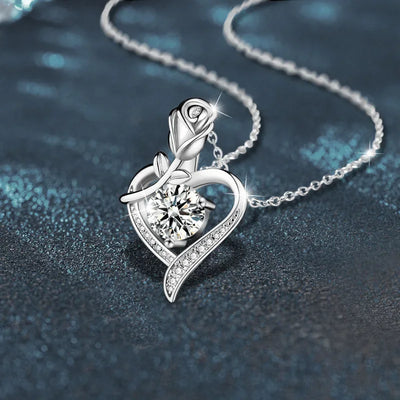 Elegant sterling silver moissanite pendant featuring a heart design and a rose accent