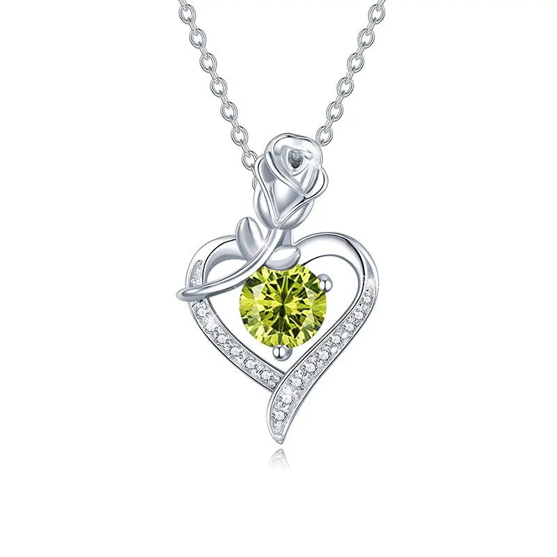 Elegant sterling silver moissanite pendant featuring a green stone and floral heart design