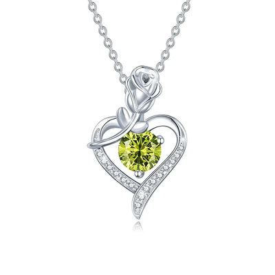 Elegant sterling silver moissanite pendant featuring a green stone and floral heart design