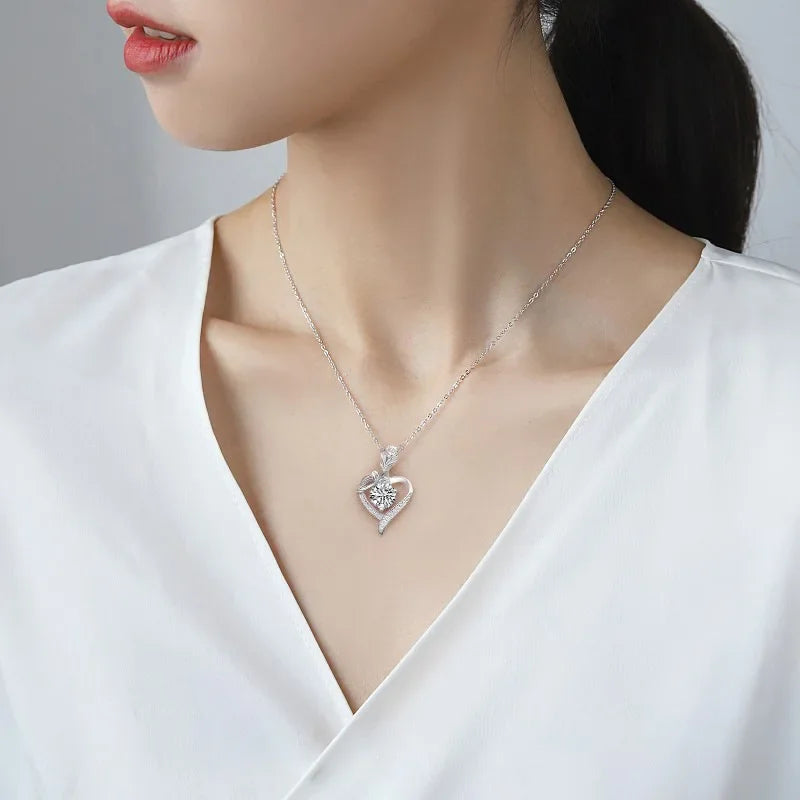 Elegant sterling silver moissanite pendant on a delicate chain, worn on a model's neckline